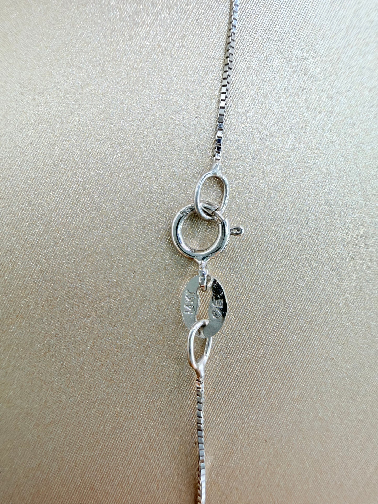 14kt white gold necklace with a flower pendant, featuring natural diamonds and ruby. Size 16”.