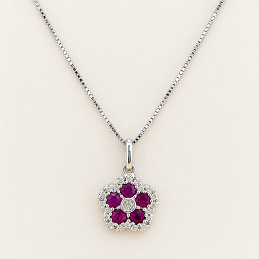 14kt white gold necklace with a flower pendant, featuring natural diamonds and ruby. Size 16”.