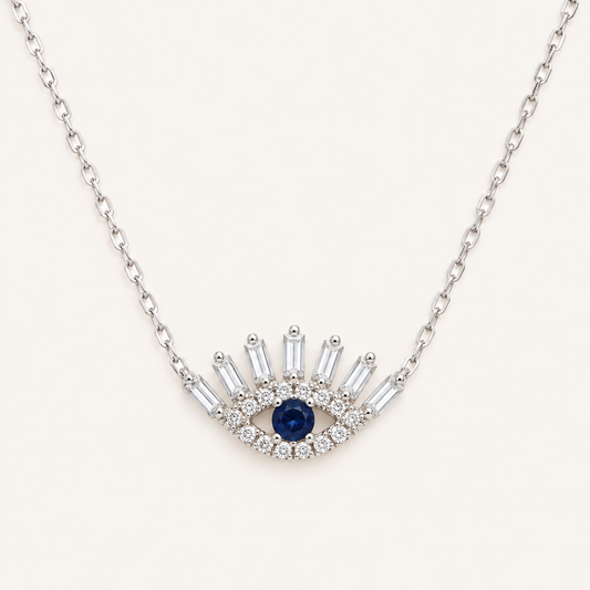 14kt gold necklace with a Turkish Evil Eye pendant, featuring natural diamonds and sapphire. 0.16 ct of natural diamonds and 0.07 ct of sapphire. Adjustable length: 16”–18”.