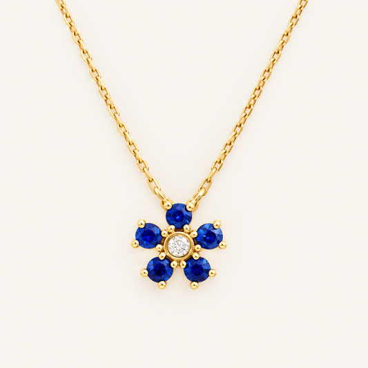 14kt gold necklace with a flower pendant, featuring a sapphire and natural diamond. 0.03 ct of natural diamonds and 0.36 ct of sapphire. Size 16”-18”