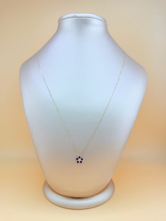 14kt gold necklace with a flower pendant, featuring a sapphire and natural diamond. 0.03 ct of natural diamonds and 0.36 ct of sapphire. Size 16”-18”