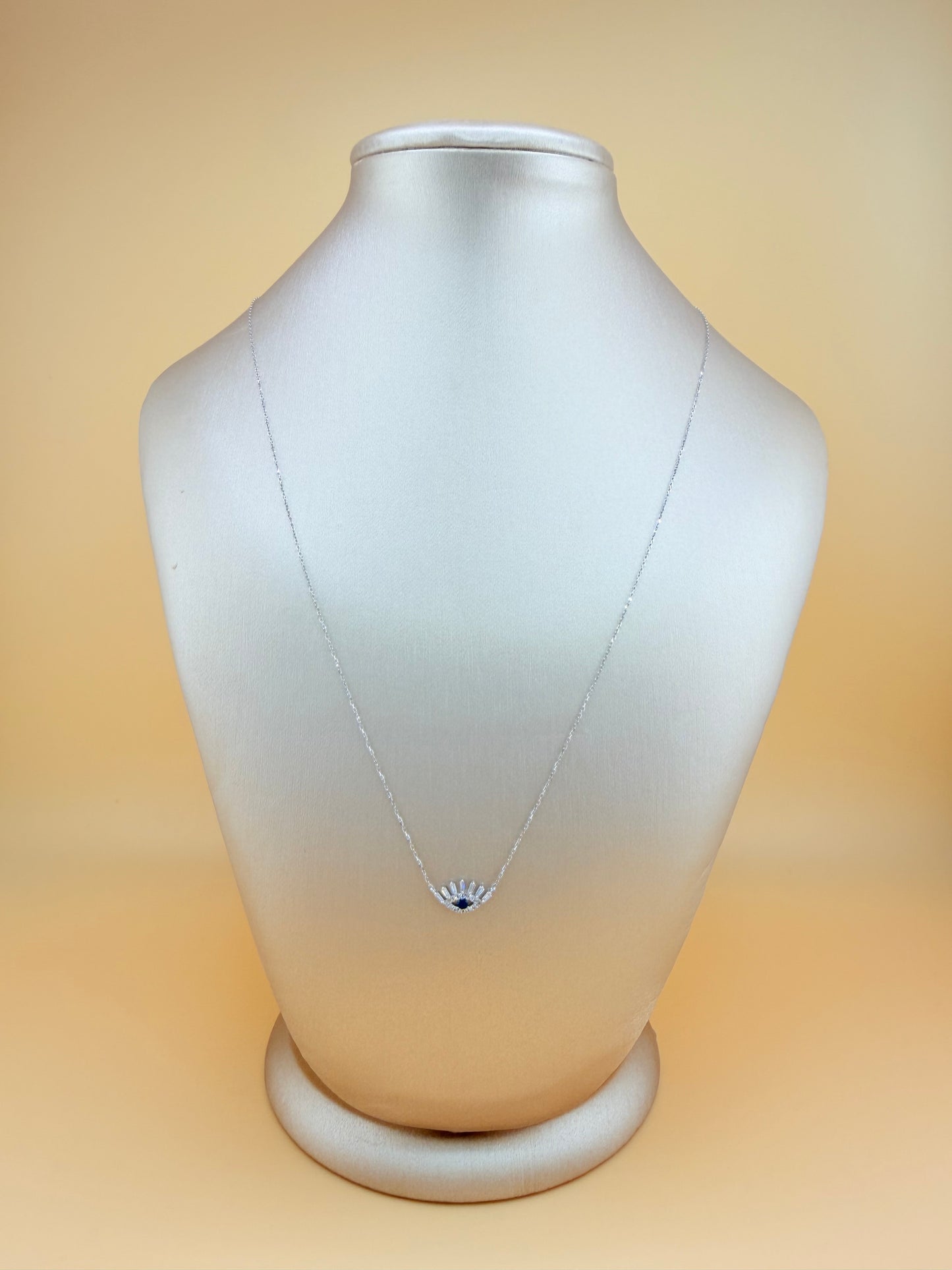 14kt gold necklace with a Turkish Evil Eye pendant, featuring natural diamonds and sapphire. 0.16 ct of natural diamonds and 0.07 ct of sapphire. Adjustable length: 16”–18”.