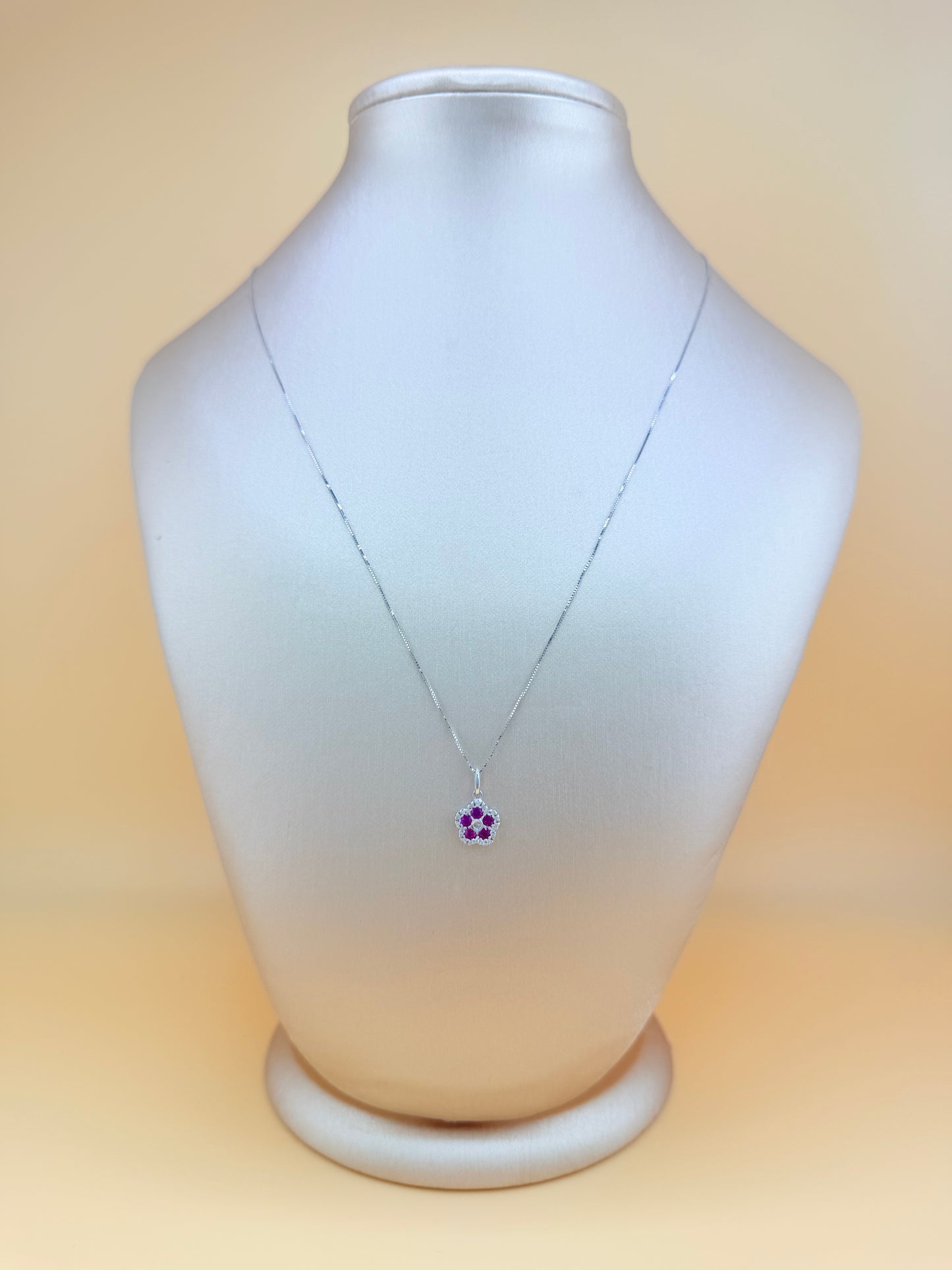 14kt white gold necklace with a flower pendant, featuring natural diamonds and ruby. Size 16”.