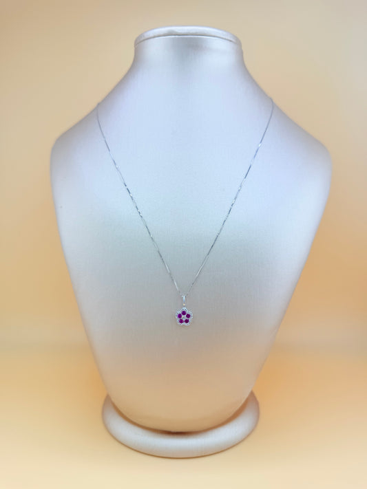14kt white gold necklace with a flower pendant, featuring natural diamonds and ruby. Size 16”.